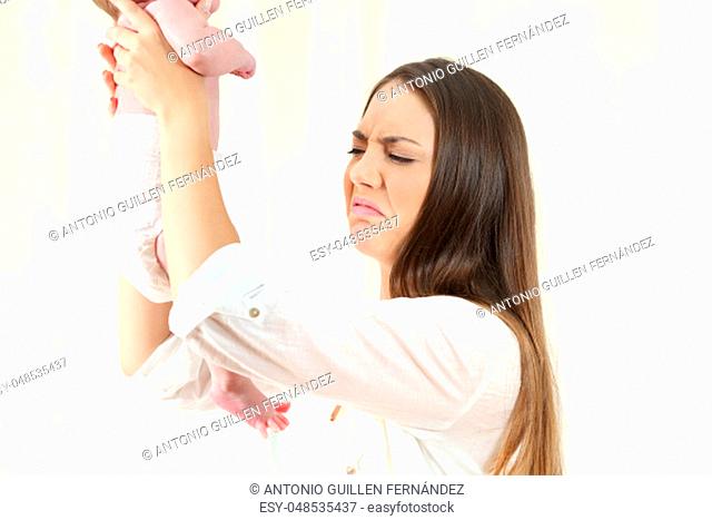 Disgusted mother checking for her baby defecation at home