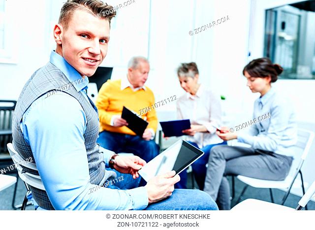 Mann als Berater mit Tablet Computer beim Consulting im Workshop