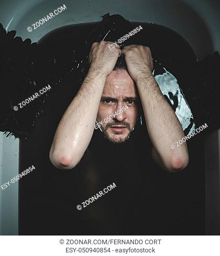 Halloween, Fallen angel, man in a bathtub with black water and wings, submerged, depression, loss