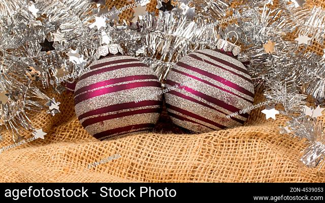 Two purple Christmas balls isolated on canvas