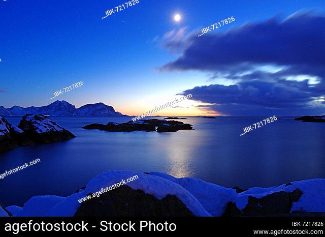 Full moon illuminates winter landscape and view over the fjord, Nyksund, Langoya, Vesteralen, Norway, Europe