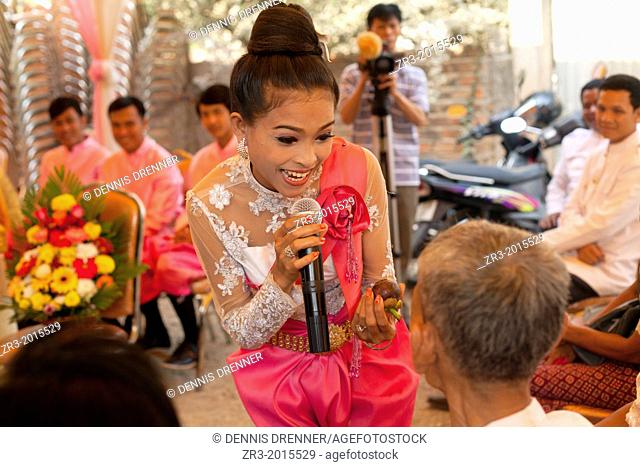 Singer at a buddhist wedding in a small village outside of Phnom Penh, Cambodia