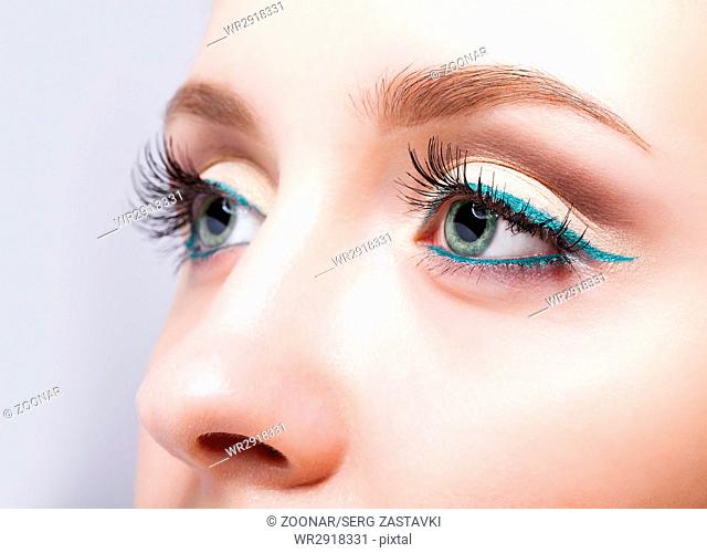 female eye zone and brows with evening green eyeliner makeup