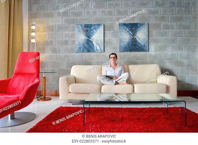 young woman watching tv at home