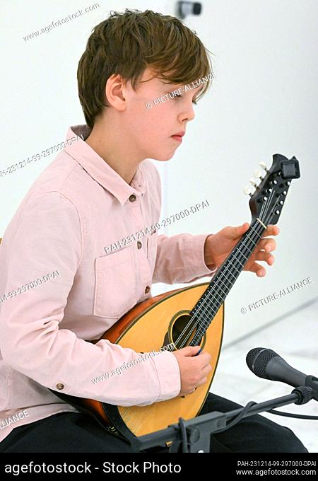 14 December 2023, Brandenburg, Potsdam: 12-year-old Milan Jürgens from the ""Bela Bartok"" music school in Berlin plays pieces by Raffaele Calace and Francesco...