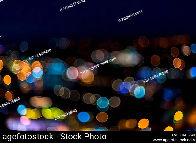 Bright lemon shaped bokeh on blue night city lights background