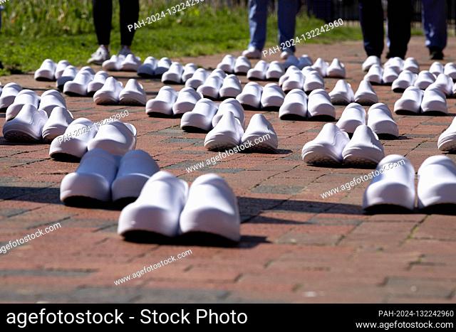 Shoes representing healthcare workers who have died of COVID-19 in the United States are lined up in Lafayette Square across from the White House on Thursday