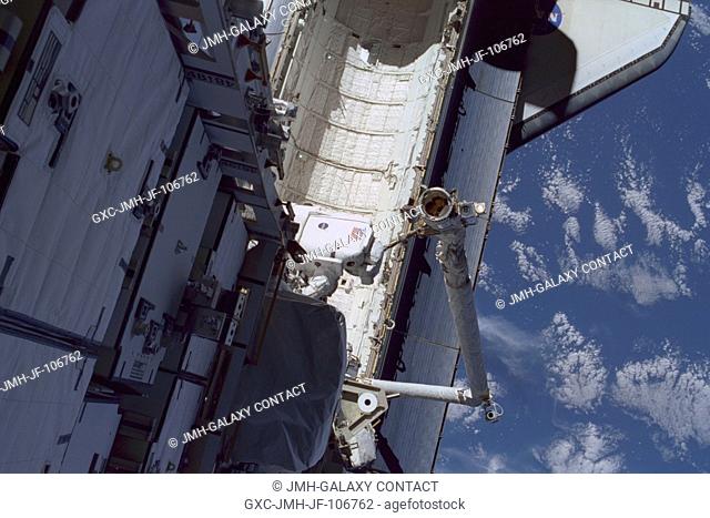 This high angle view shows astronaut Carlos I. Noriega, STS-97 mission specialist, traversing over Endeavour's cargo bay during the flight's first space walk on...