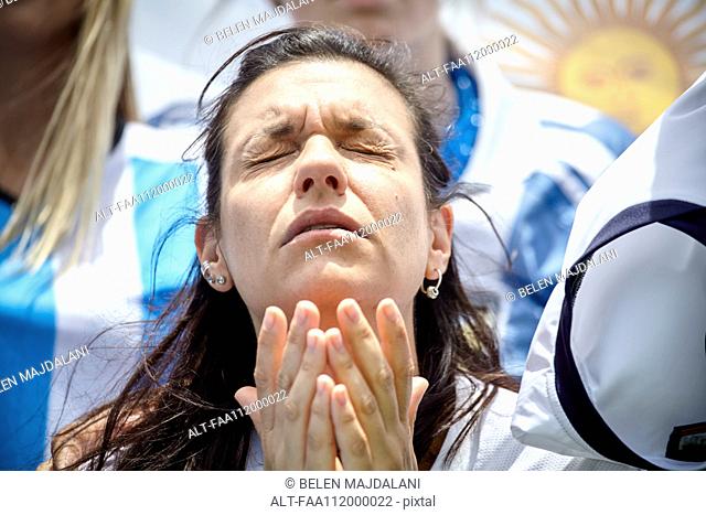 Argentinian football fan with anguished expression on face at match
