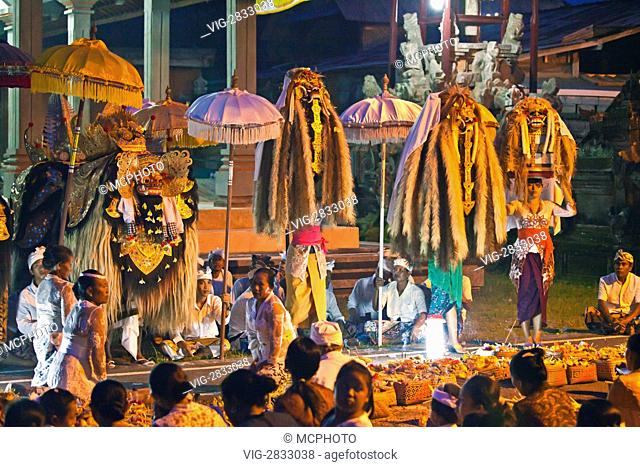 A BARONG COSTUME and LION MASKS used in traditional LEGONG dancing are delivered during a HINDU PROCESSION for a temple anniversary - UBUD, BALI - 03/12/2010