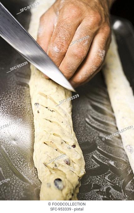 Making olive bread scoring with a knife