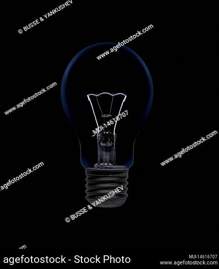 Light bulb with filament isolated on black background