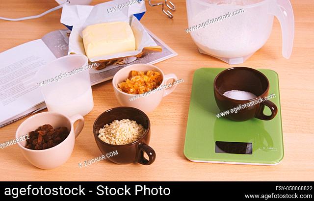 home baking ingredients for traditional german stollen cake recipe - a fruit loaf or bread - on kitchen table
