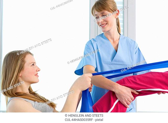 Doctor examining girls legs in office