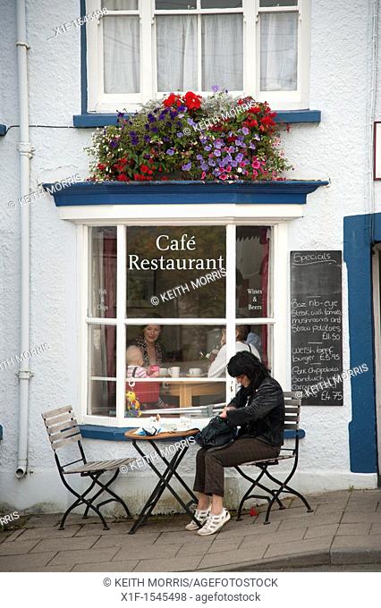 People eating breakfast at an outdoor cafe, Newport, Pembrokeshire Wales UK