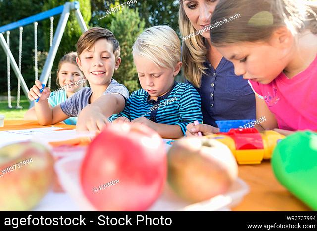 Mum painting pictures with their children and during lunch break