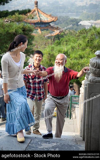 Chinese Family Walking In Jing Shan Park