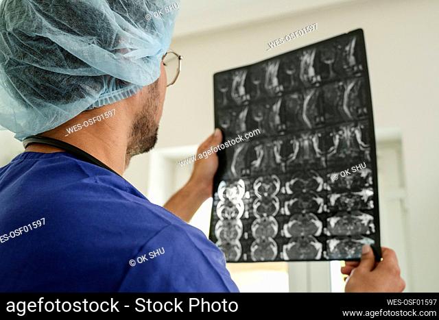 Radiologist examining x-ray at clinic