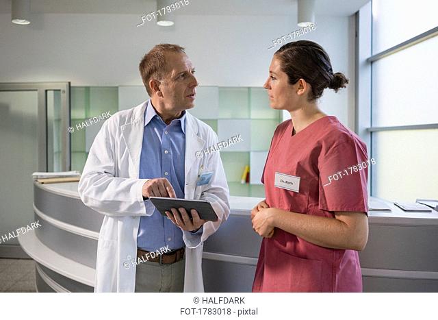 Doctors using digital tablet in hospital