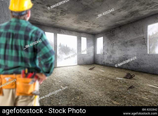 Contractor in hard hat and construction belt facing vacant empty abandoned room of house