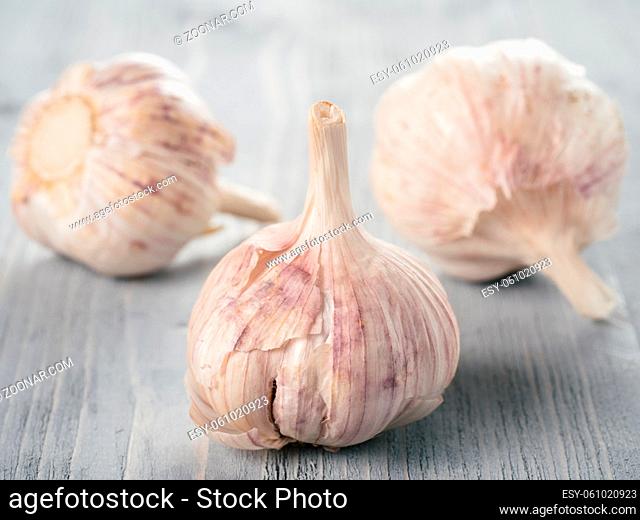Three garlic bulb close up on grey wooden table. Garlic Bulb on gray wooden background