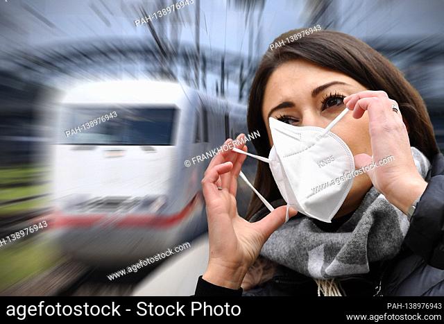 PHOTO MONTAGE: Deutsche Bahn examines the introduction of an FFP2 mask requirement. Young woman puts on an FFP2 face mask, mask