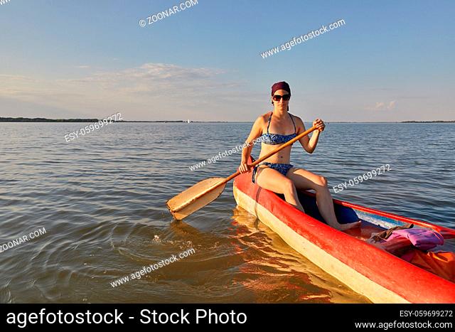 Canoeing in late afternoon sunlight, Lake Tisza, Hungary