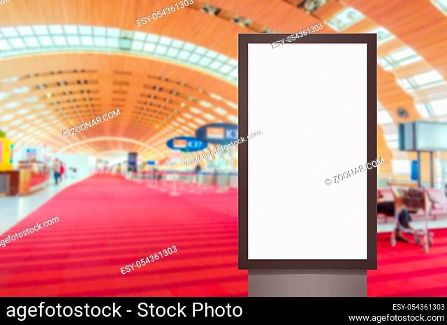 mock up of vertical blank advertising billboard or light box showcase with people waiting at airport, copy space for your text message or media content
