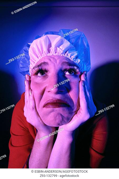 Saddened woman with shower cap