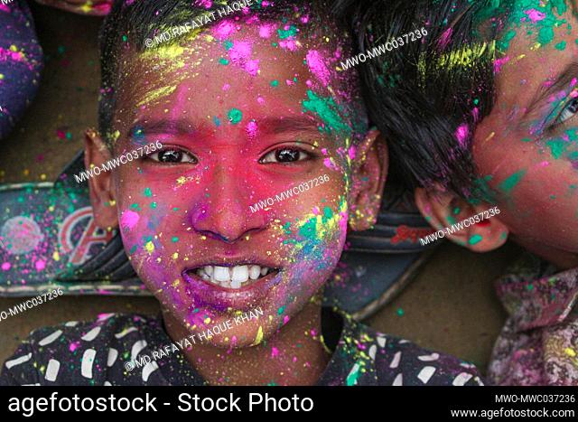 Children with bright colorful painted faces at a Bangladeshi Tea garden during the annual Hindu Festival of Colors, known as Holi Festival marking the onset of...