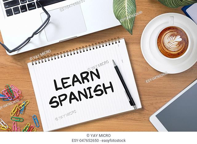 Learn Spanish Tablet with blank black screen and coffee cup