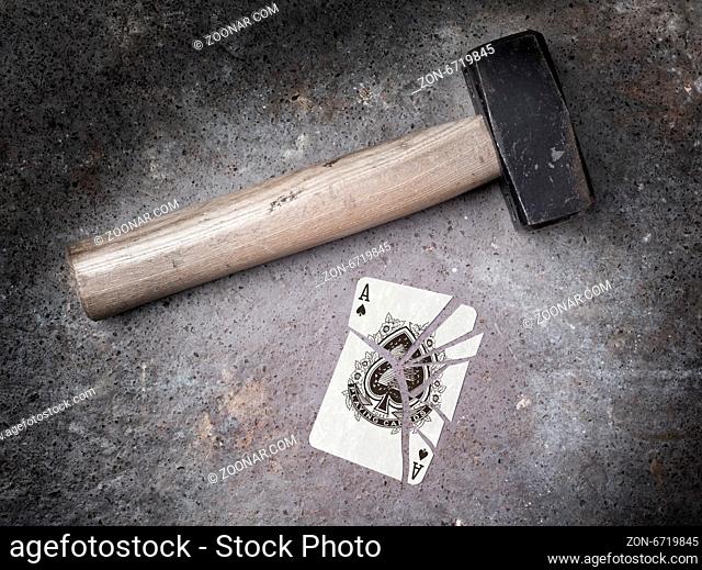 Hammer with a broken card, vintage look, ace of spades