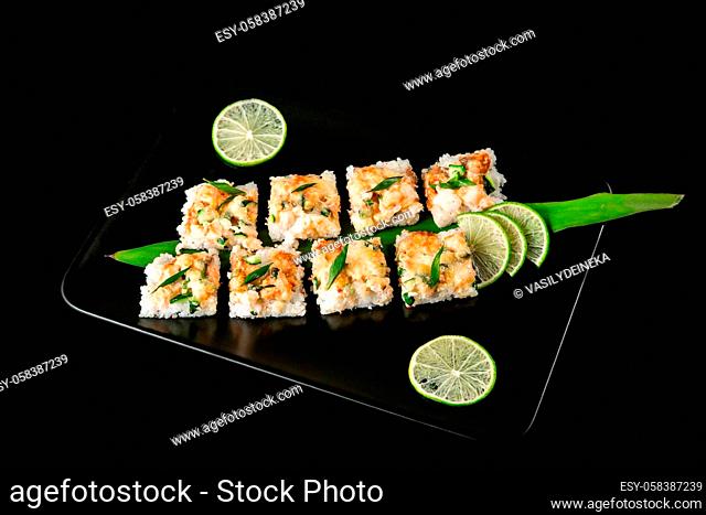 large set of Japanese rolls on a black background. Salmon, tuna, smoked eel. Close-up, top view