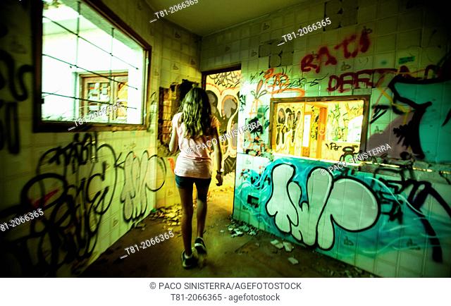 Girl with graffiti abandoned cascade in Peniscola, Castellón, Valencia, Spain