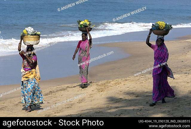 Women beach fruit sellers Anjuna weekly hippy flea market Goa India