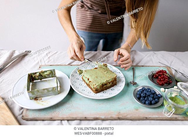 Woman preparing vegan matcha cake