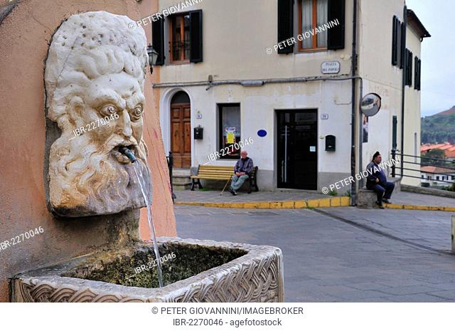 Fountain with stone mask in Rio nell'Elba, Tuscany, Italy, Europe