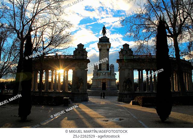 Sunset behind the monument to Alfonso XII of Spain in Retiro Park at Madrid, built in memory of the king that not only restored Borbón Spanish dinasty in 1875...