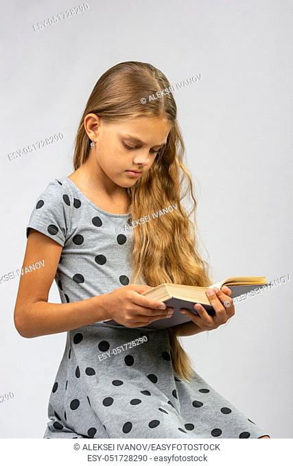 Teen girl reads a book