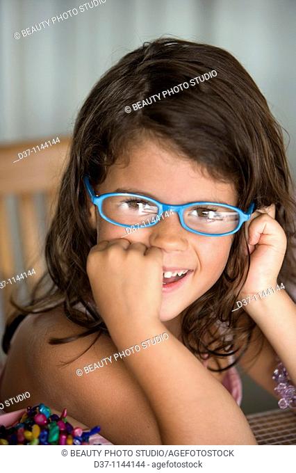 Little caucasian girl wearing glasses and smiling