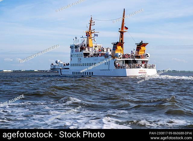 16 August 2023, Lower Saxony, Norddeich: A ferry ship of the AG Reederei Norden-Frisia is underway during the crossing from the island of Juist on the North Sea...
