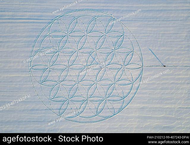 10 February 2021, Brandenburg, Jacobsdorf: The symbol ""Flower of Life"" can be seen as a huge pattern in the snow (aerial view with a drone)