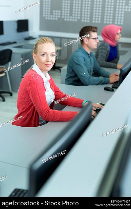 Beautiful blonde woman working in her office. Cooperating office space. Sharing office with colleagues