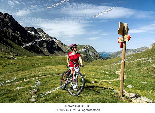 Italy Lombardy Stelvio National Park the Alps Rezzalo valley bike and signs