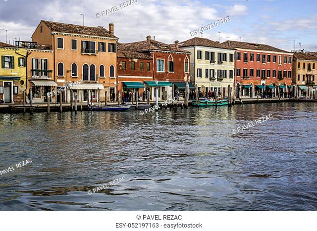 The picturesque island of Murano in the Venetian Lagoon is interwoven with canals and narrow streets between historic houses and palaces with beautiful gardens