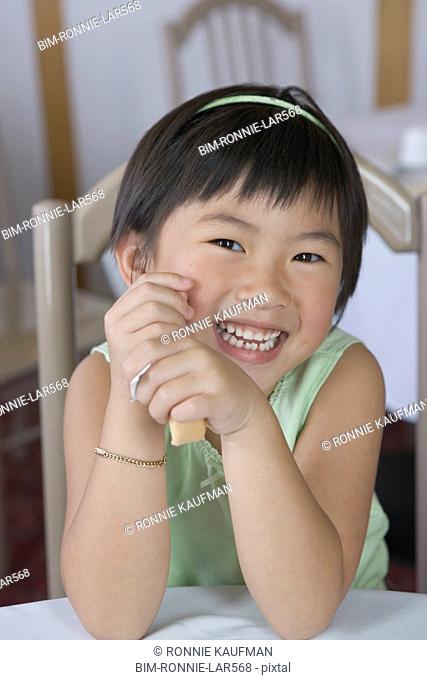 Young girl holding a cookie