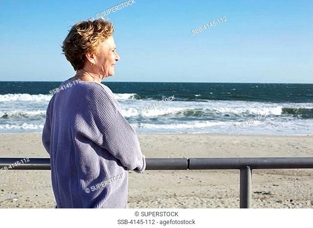 Woman standing on the beach, Far Rockaway, Queens, New York City, New York State, USA