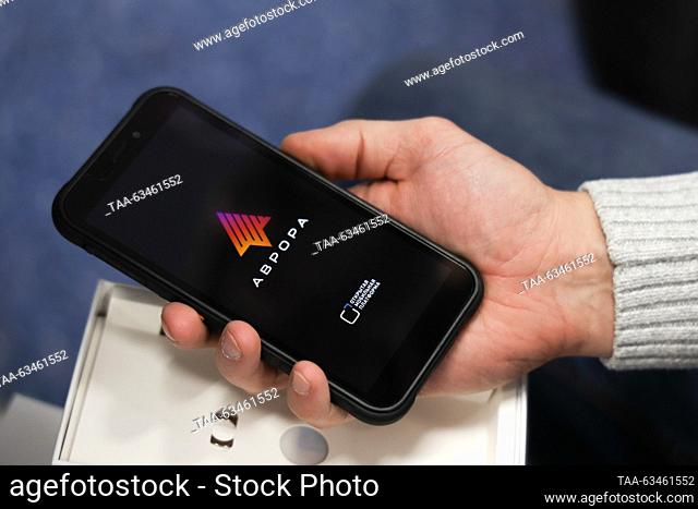 RUSSIA, NOVOSIBIRSK - OCTOBER 17, 2023: A person turns on a new F+ R570e smartphone as Open Mobile Platform lets users beta test the Russian-made Aurora OS at...