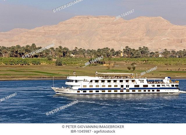 View of West Thebes over the Nile with cruise ship, Luxor, Egypt, Africa