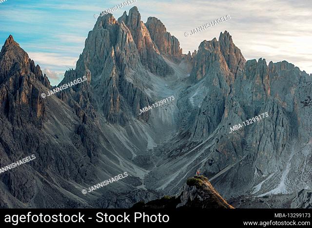 Hiker in front of impressive scenery on Monte Campedelle, Dolomites, Italy